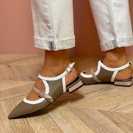 Graue Ballerinas mit auffälligem Spannriemen und spitz zulaufender Zehenpartie